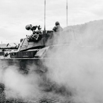 grayscale photo of soldiers on battle tank